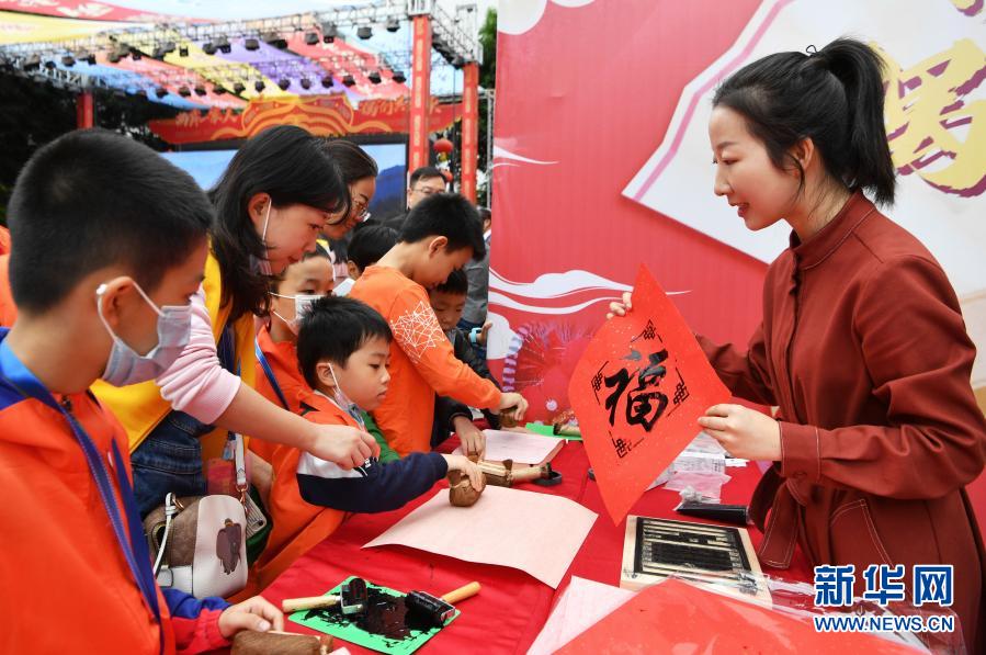 兩岸青少年在木刻拓印攤位上學(xué)習(xí)傳統(tǒng)拓印技藝（11月21日攝）。新華社記者 魏培全 攝